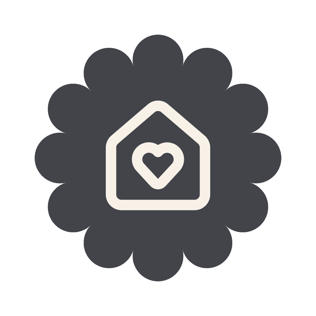 Icon of a white heart inside a house outline centered on a dark petal-shaped background.
